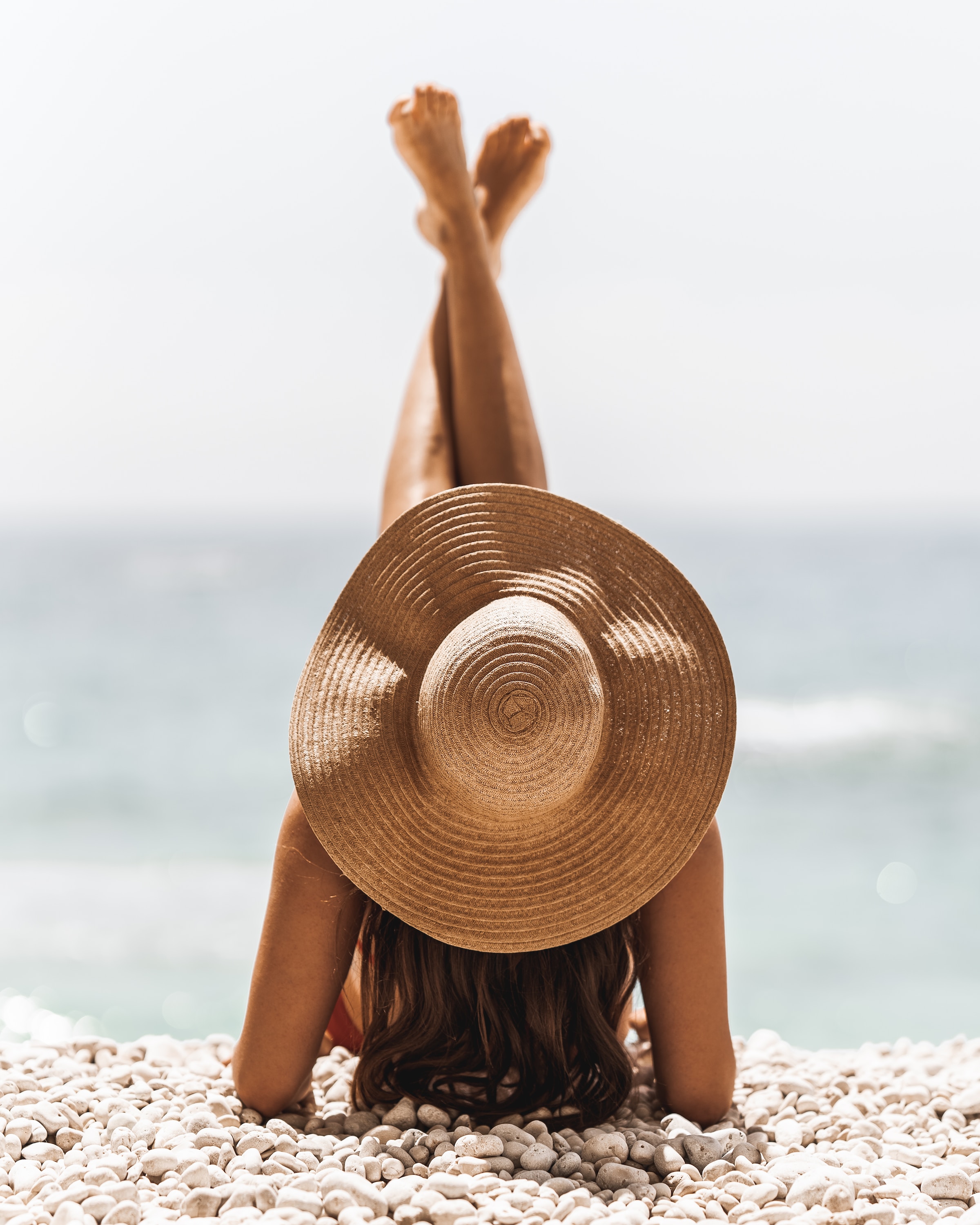 woman wearing sun hat at the beach