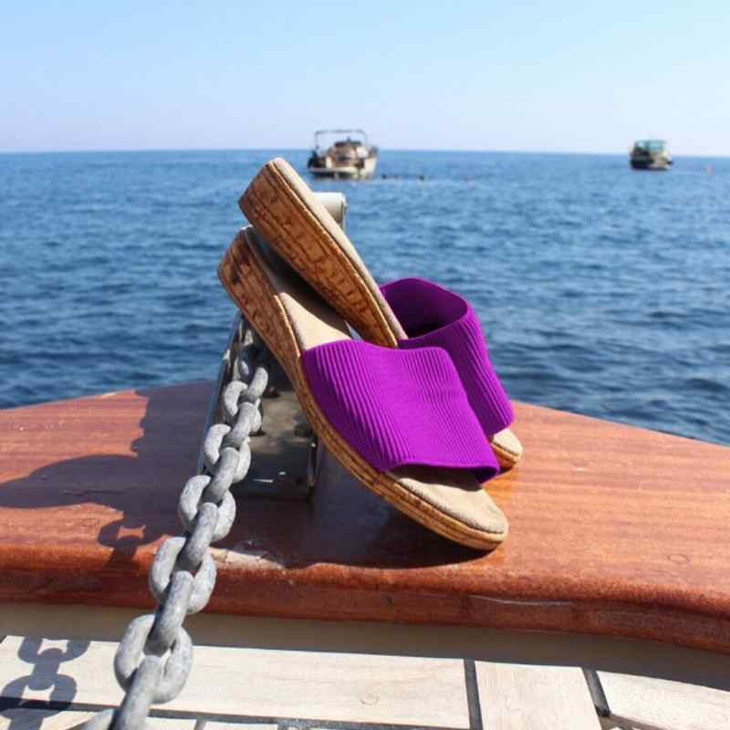 slide sandals sitting on a boat at sea