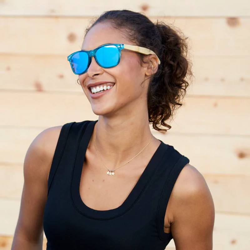 Woman wearing bamboo mirrored sunglasses