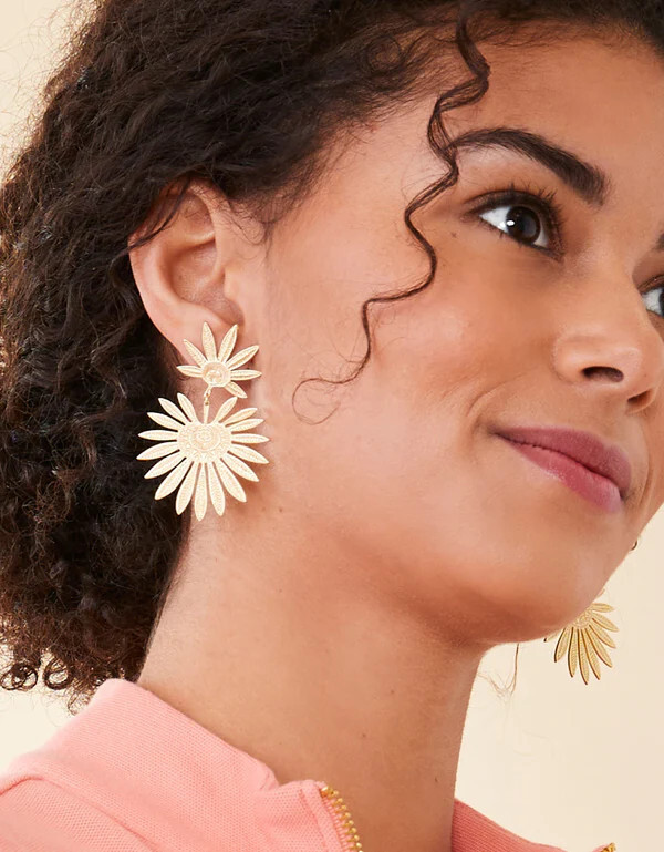woman wearing gold palmetto earrings