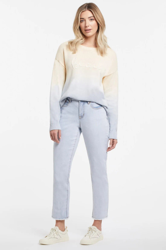 woman wearing relaxed fit ankle jeans and coastal sweater